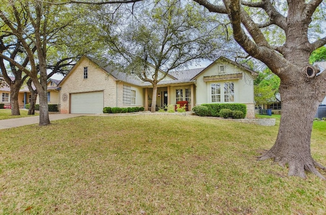 204 Whippoorwill Cv, Georgetown, TX 78633 - view of front of property with concrete driveway, a front lawn, a garage, stucco siding, and central AC