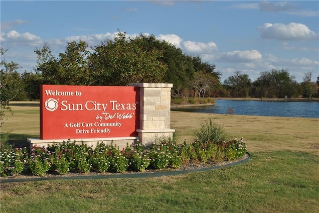 204 Whippoorwill Cv, Georgetown, TX 78633 - community / neighborhood sign featuring a water view and a lawn