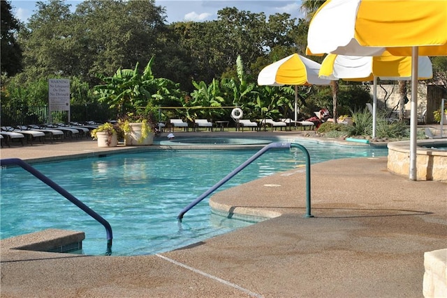 204 Whippoorwill Cv, Georgetown, TX 78633 - community pool featuring a patio area and view of wooded area