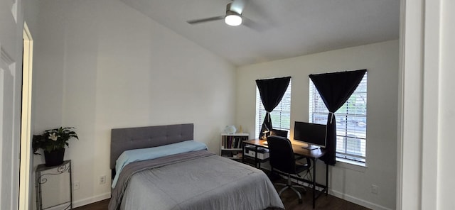 bedroom with baseboards, ceiling fan, dark wood-style floors, and lofted ceiling