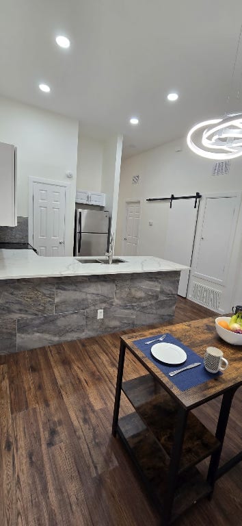 dining room with recessed lighting and dark wood-style floors