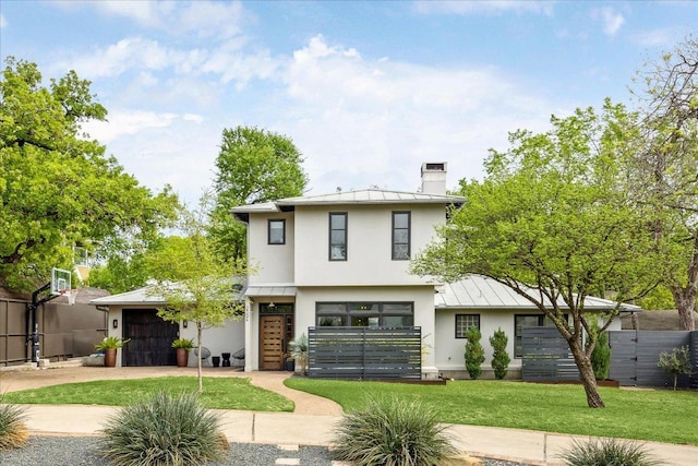 2304 Mccullough St, Austin, TX 78703 - view of front of house featuring stucco siding, a standing seam roof, a chimney, an attached garage, and metal roof