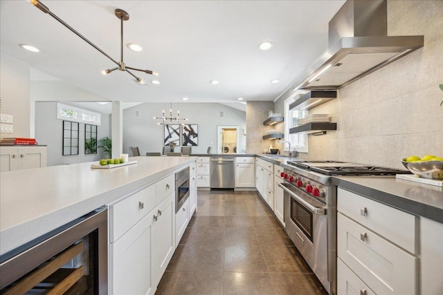 2304 Mccullough St, Austin, TX 78703 - kitchen with appliances with stainless steel finishes, wine cooler, a chandelier, wall chimney exhaust hood, and healthy amount of natural light