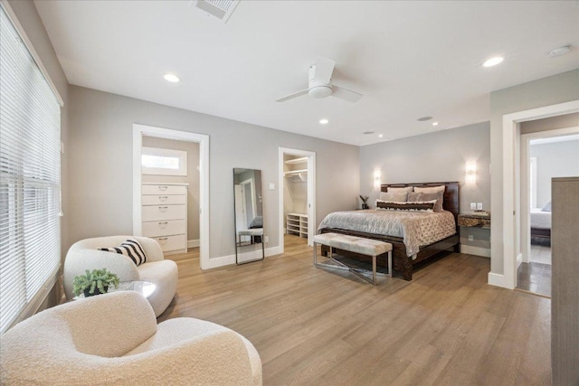 2304 Mccullough St, Austin, TX 78703 - bedroom with light wood-style floors, a spacious closet, baseboards, and recessed lighting