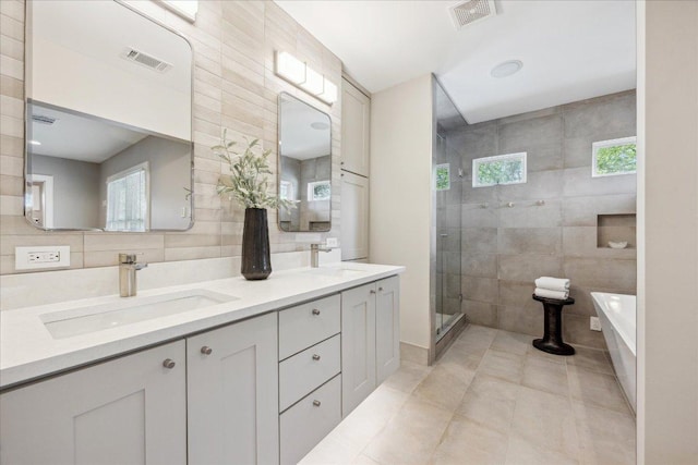 2304 Mccullough St, Austin, TX 78703 - full bath with tile walls, tile patterned flooring, a freestanding tub, a stall shower, and double vanity