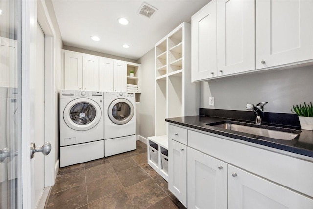 2304 Mccullough St, Austin, TX 78703 - washroom featuring washer and clothes dryer, cabinet space, dark stone finish flooring, recessed lighting, and baseboards