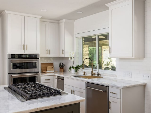 6022 Tonkowa Trl, Georgetown, TX 78628 - kitchen featuring stainless steel appliances, light stone countertops, white cabinetry, backsplash, and recessed lighting