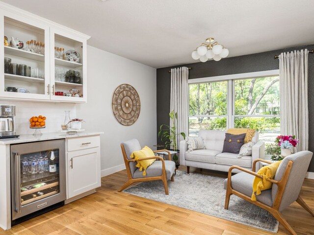 6022 Tonkowa Trl, Georgetown, TX 78628 - living room with beverage cooler, a dry bar, and light wood finished floors