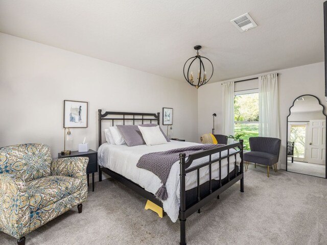 6022 Tonkowa Trl, Georgetown, TX 78628 - bedroom with light carpet and a chandelier