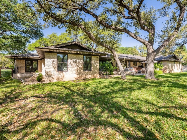6022 Tonkowa Trl, Georgetown, TX 78628 - back of house with brick siding, a yard, and a patio