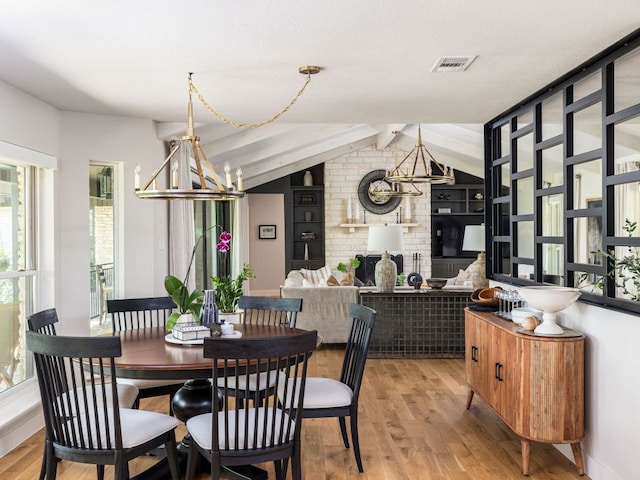 6022 Tonkowa Trl, Georgetown, TX 78628 - dining room featuring plenty of natural light, light wood-style floors, and a chandelier