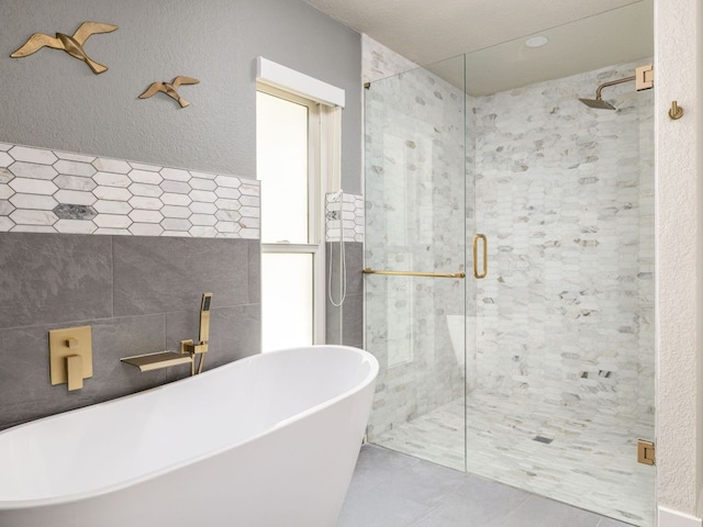 6022 Tonkowa Trl, Georgetown, TX 78628 - full bath with a shower stall, a soaking tub, and tile patterned floors