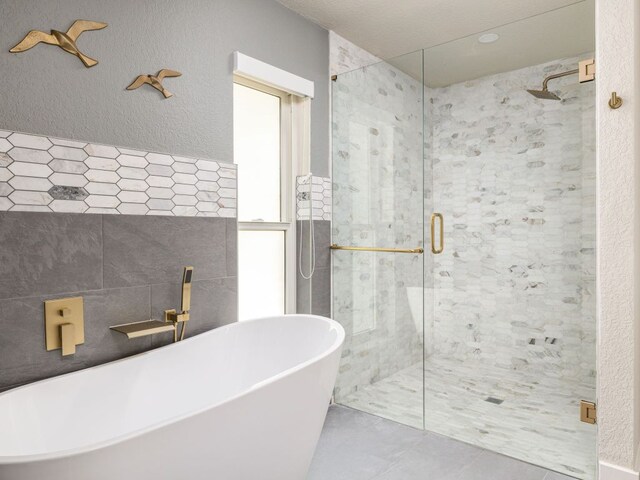 6022 Tonkowa Trl, Georgetown, TX 78628 - full bath featuring a stall shower, a soaking tub, and tile patterned floors