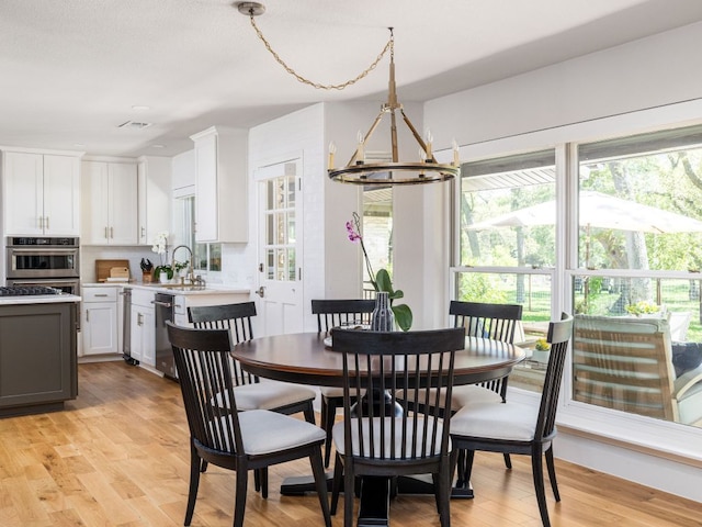 6022 Tonkowa Trl, Georgetown, TX 78628 - dining space featuring a chandelier and light wood-type flooring