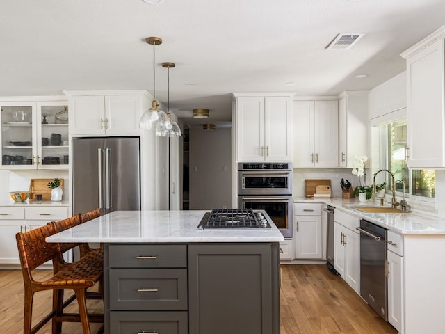 6022 Tonkowa Trl, Georgetown, TX 78628 - kitchen featuring appliances with stainless steel finishes, gray cabinets, and white cabinetry
