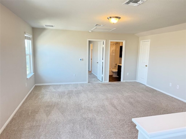 3409 Brywood Dr, Pflugerville, TX 78660 - unfurnished bedroom featuring carpet floors, baseboards, ensuite bath, and attic access