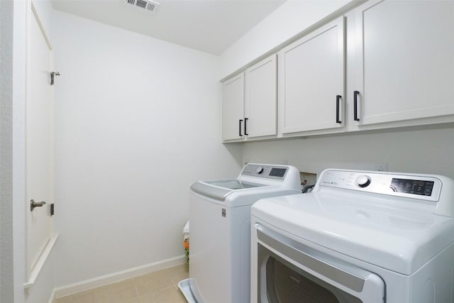 11700 Misty White Dr, Austin, TX 78717 - washroom with cabinet space, washing machine and dryer, and light tile patterned floors