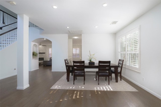11700 Misty White Dr, Austin, TX 78717 - dining area with arched walkways, wood finished floors, stairway, and recessed lighting