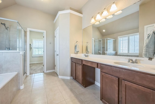3505 Grail Hollows Rd, Pflugerville, TX 78660 - bathroom with lofted ceiling, double vanity, a stall shower, a bath, and tile patterned flooring