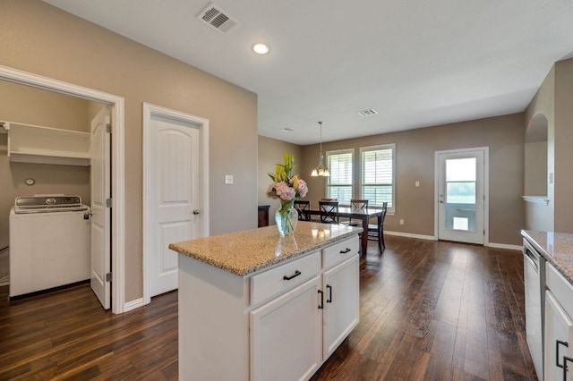 3505 Grail Hollows Rd, Pflugerville, TX 78660 - kitchen featuring washer / dryer, stainless steel dishwasher, dark wood finished floors, white cabinets, and recessed lighting