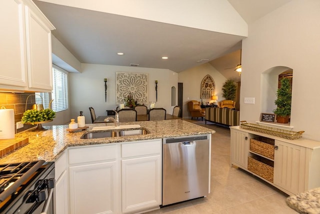 702 Silo St, San Marcos, TX 78666 - kitchen with stainless steel dishwasher, a peninsula, range with gas stovetop, open floor plan, and white cabinets