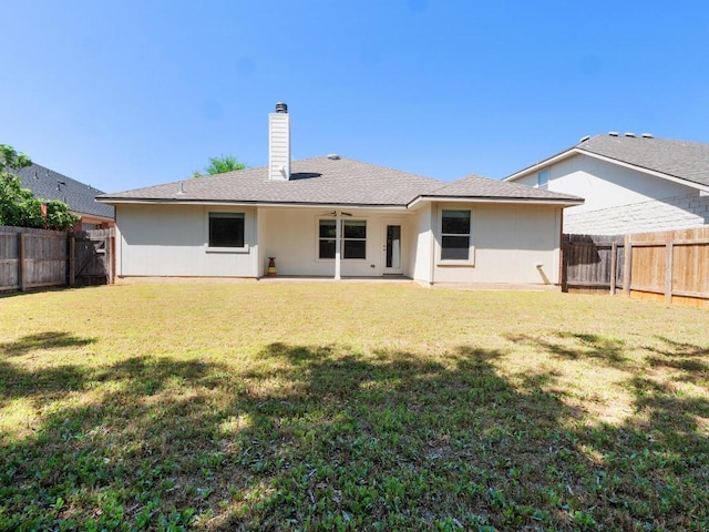 429 Falcon Ln, Leander, TX 78641 - back of property with a fenced backyard and a chimney