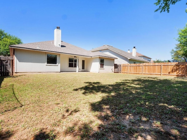 429 Falcon Ln, Leander, TX 78641 - back of property featuring a fenced backyard, a chimney, and a ceiling fan