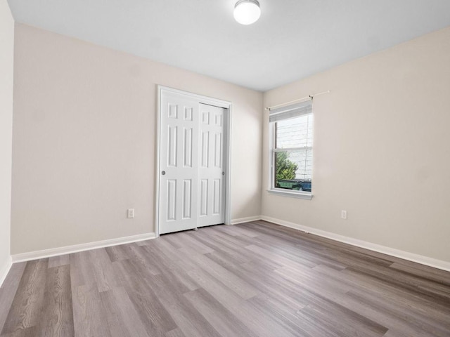 429 Falcon Ln, Leander, TX 78641 - unfurnished bedroom featuring wood finished floors and a closet