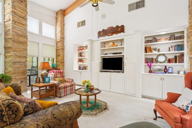 901 Blaylock Dr, Salado, TX 76571 - living room with a towering ceiling, ceiling fan, built in shelves, and light carpet