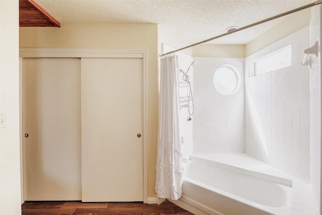 19 Deerfield Dr Unit 2, Wimberley, TX 78676 - bathroom with shower / tub combo, wood finished floors, and a textured ceiling