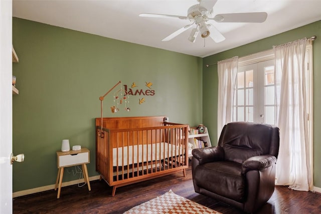 19 Deerfield Dr Unit 2, Wimberley, TX 78676 - bedroom with wood finished floors, ceiling fan, a crib, and french doors