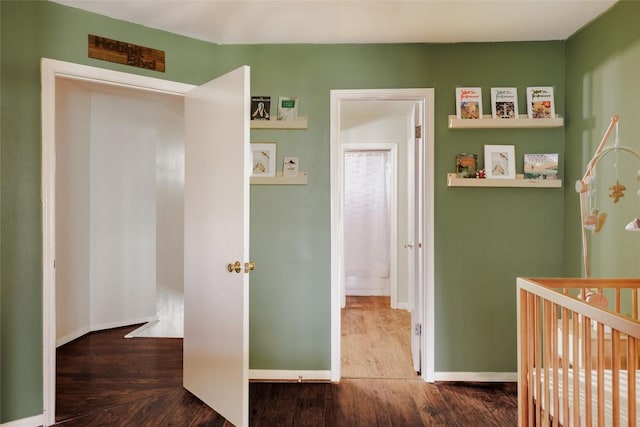 19 Deerfield Dr Unit 2, Wimberley, TX 78676 - bedroom featuring wood finished floors and a crib