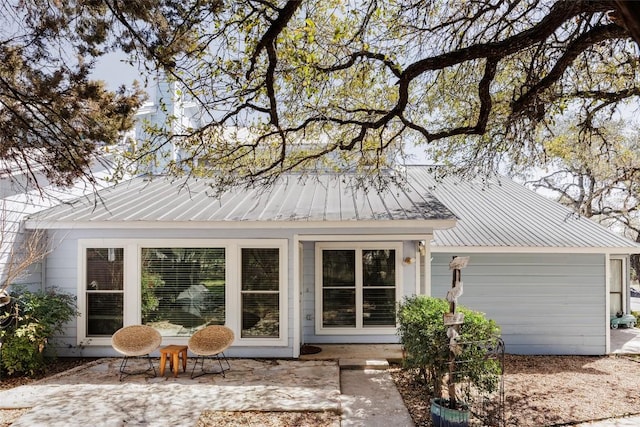 19 Deerfield Dr Unit 2, Wimberley, TX 78676 - rear view of house with a metal roof and a patio