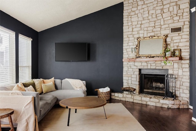 19 Deerfield Dr Unit 2, Wimberley, TX 78676 - living room featuring lofted ceiling, wood finished floors, and a fireplace