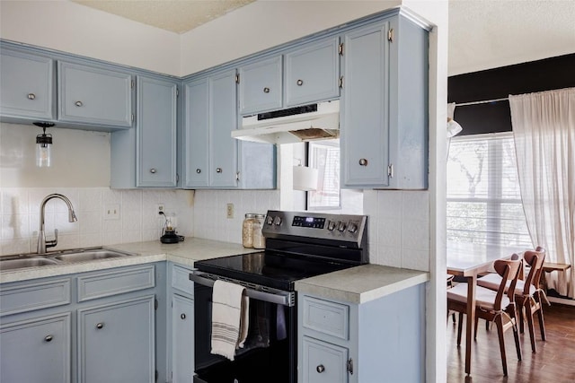 19 Deerfield Dr Unit 2, Wimberley, TX 78676 - kitchen with electric range, under cabinet range hood, light countertops, and gray cabinetry