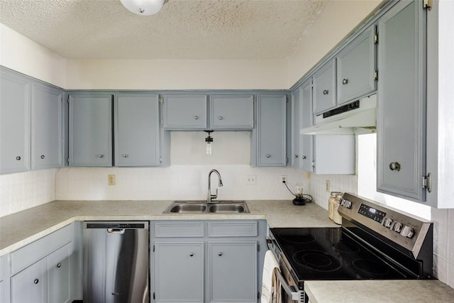 19 Deerfield Dr Unit 2, Wimberley, TX 78676 - kitchen with stainless steel appliances, under cabinet range hood, decorative backsplash, a textured ceiling, and light countertops