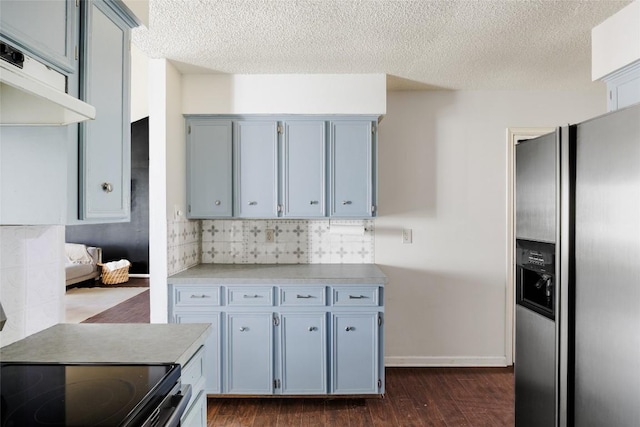 19 Deerfield Dr Unit 2, Wimberley, TX 78676 - kitchen featuring stainless steel refrigerator with ice dispenser, dark wood-type flooring, tasteful backsplash, a textured ceiling, and light countertops