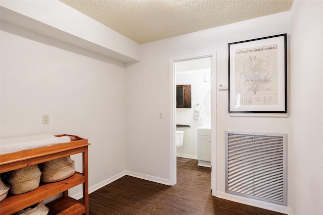 19 Deerfield Dr Unit 2, Wimberley, TX 78676 - corridor featuring dark wood finished floors and a textured ceiling