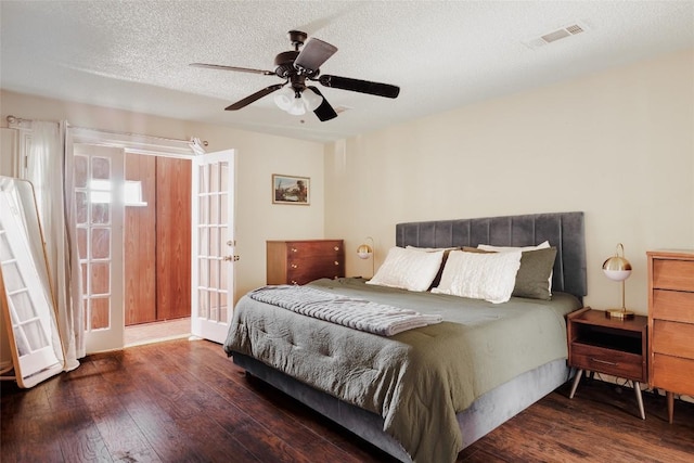 19 Deerfield Dr Unit 2, Wimberley, TX 78676 - bedroom with wood-type flooring, french doors, a textured ceiling, and ceiling fan