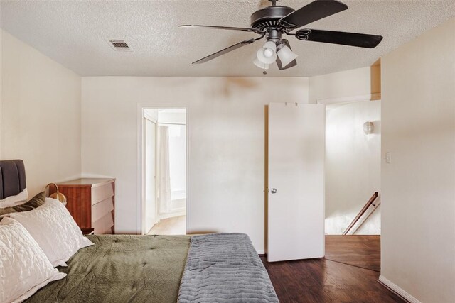 19 Deerfield Dr Unit 2, Wimberley, TX 78676 - bedroom featuring wood finished floors, a textured ceiling, a ceiling fan, and connected bathroom