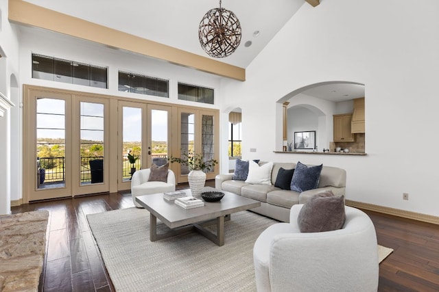 219 Jack Nicklaus Dr, Austin, TX 78738 - living area featuring high vaulted ceiling, dark wood-style flooring, french doors, and arched walkways