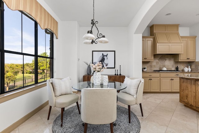 219 Jack Nicklaus Dr, Austin, TX 78738 - dining room with healthy amount of natural light, arched walkways, a chandelier, and light tile patterned floors