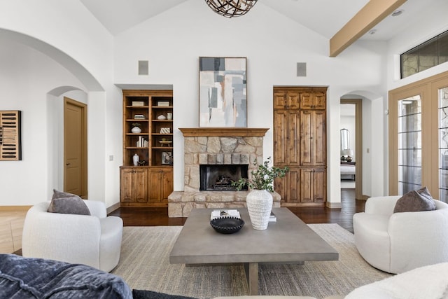 219 Jack Nicklaus Dr, Austin, TX 78738 - living room featuring high vaulted ceiling, arched walkways, a fireplace, and wood finished floors