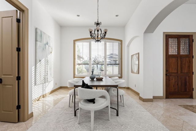 219 Jack Nicklaus Dr, Austin, TX 78738 - dining space featuring arched walkways, a chandelier, and light tile patterned floors