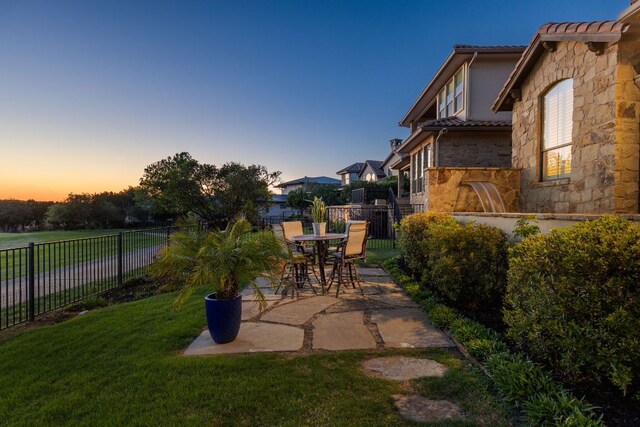 219 Jack Nicklaus Dr, Austin, TX 78738 - patio terrace at dusk with a patio and a fenced backyard