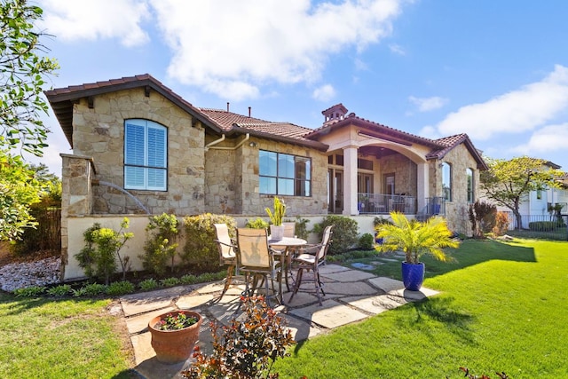 219 Jack Nicklaus Dr, Austin, TX 78738 - back of property featuring stone siding, a patio, and a tiled roof