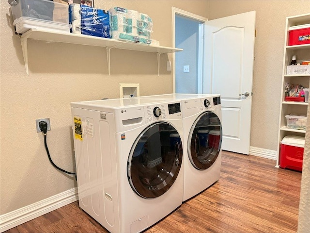2201 Ezra Ct, Cedar Park, TX 78613 - washroom featuring washer and clothes dryer, wood finished floors, and baseboards