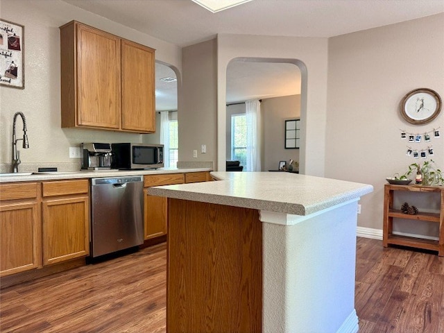 2201 Ezra Ct, Cedar Park, TX 78613 - kitchen with stainless steel appliances, dark wood-type flooring, arched walkways, and light countertops