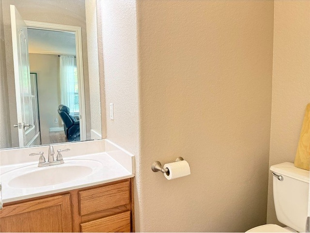 2201 Ezra Ct, Cedar Park, TX 78613 - bathroom featuring toilet, vanity, and a textured wall