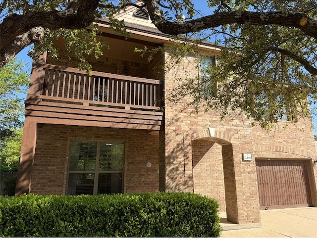 2201 Ezra Ct, Cedar Park, TX 78613 - view of front of home featuring a balcony, a garage, driveway, and brick siding